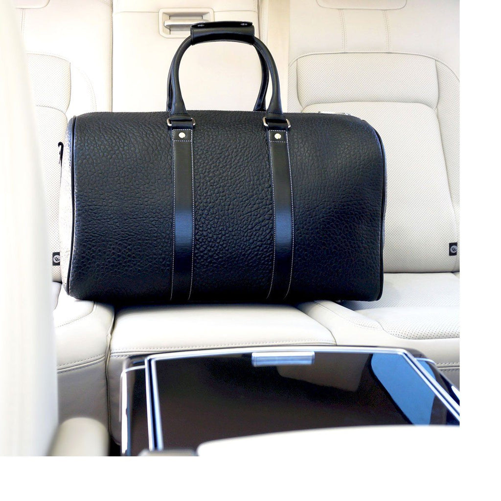 Our Black Leather Duffle bag at home in a white leather interior
